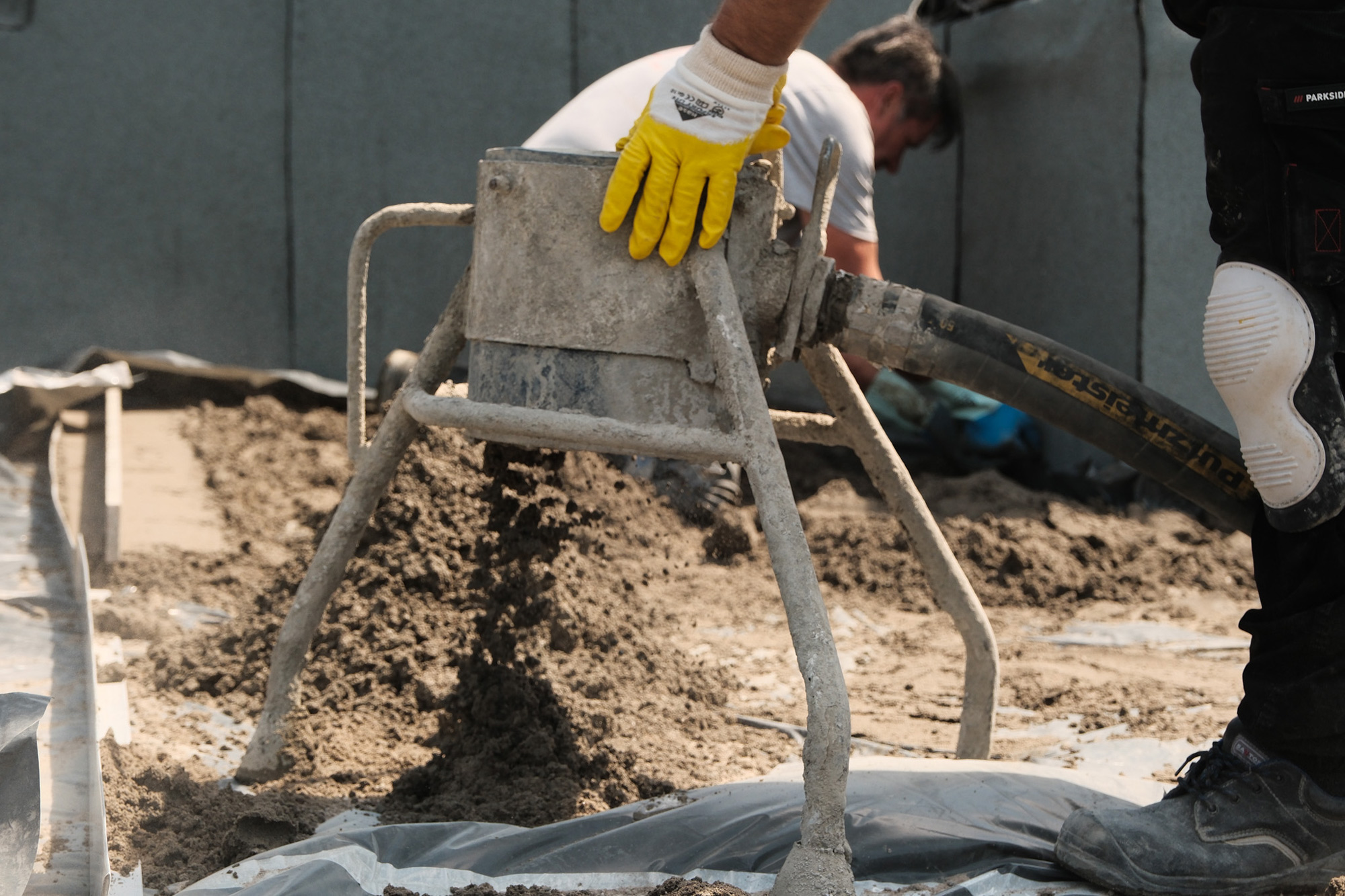 Einbau von Zementestrich auf einer Baustelle draußen.